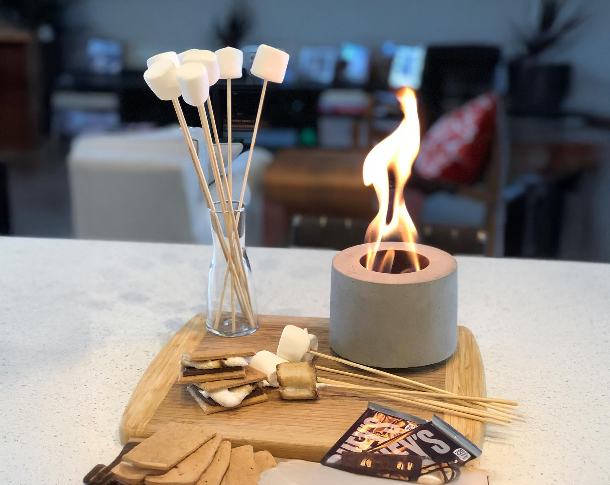 Fire pit with marshmallows on sticks, wooden tray