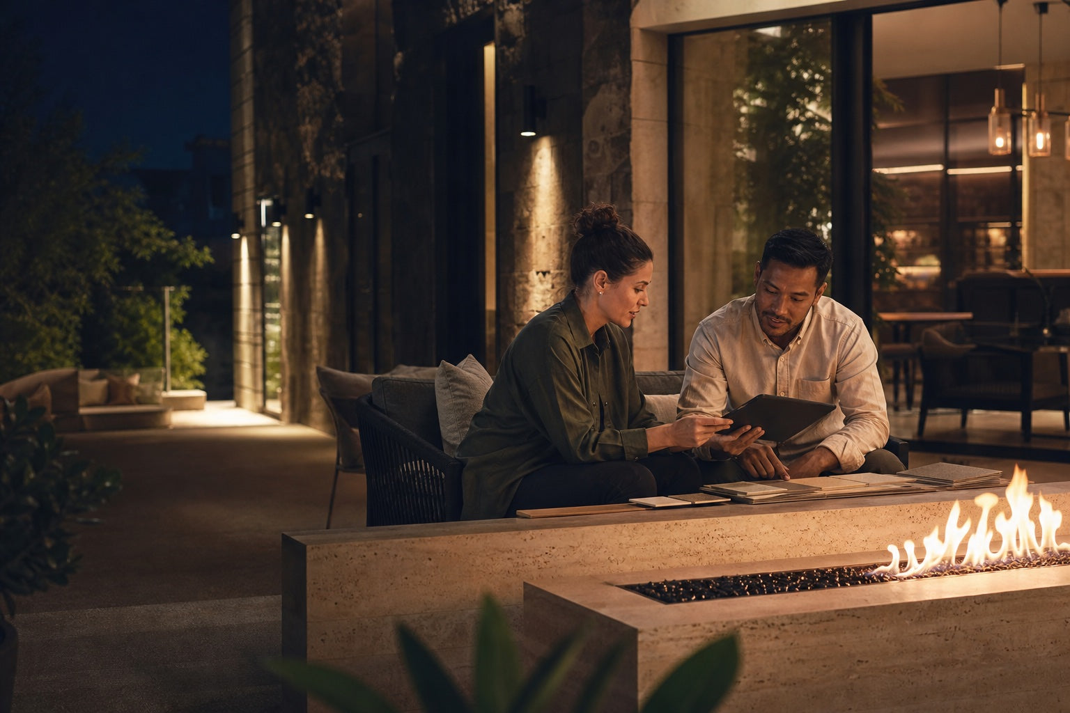 Hospitality and fireplace professionals reviewing a clean-burning fire installation
